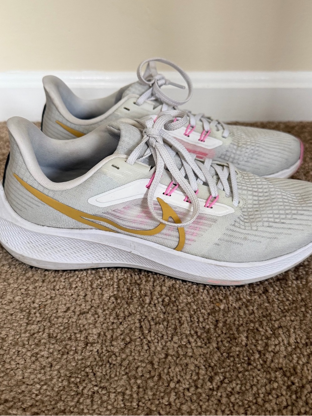 Nike Women's White Sneakers with Gold Swoosh and Pink Accents